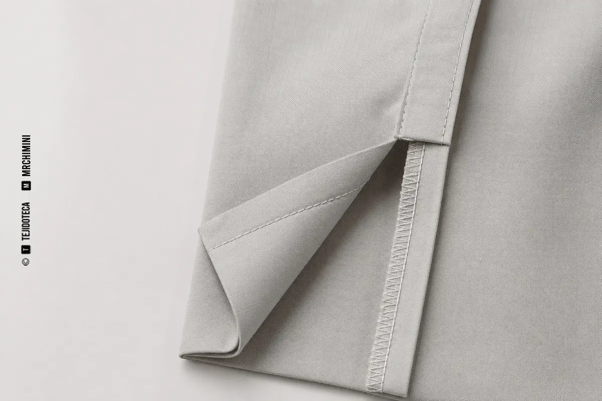Representación técnica de costura sobrecargada en confección textil.