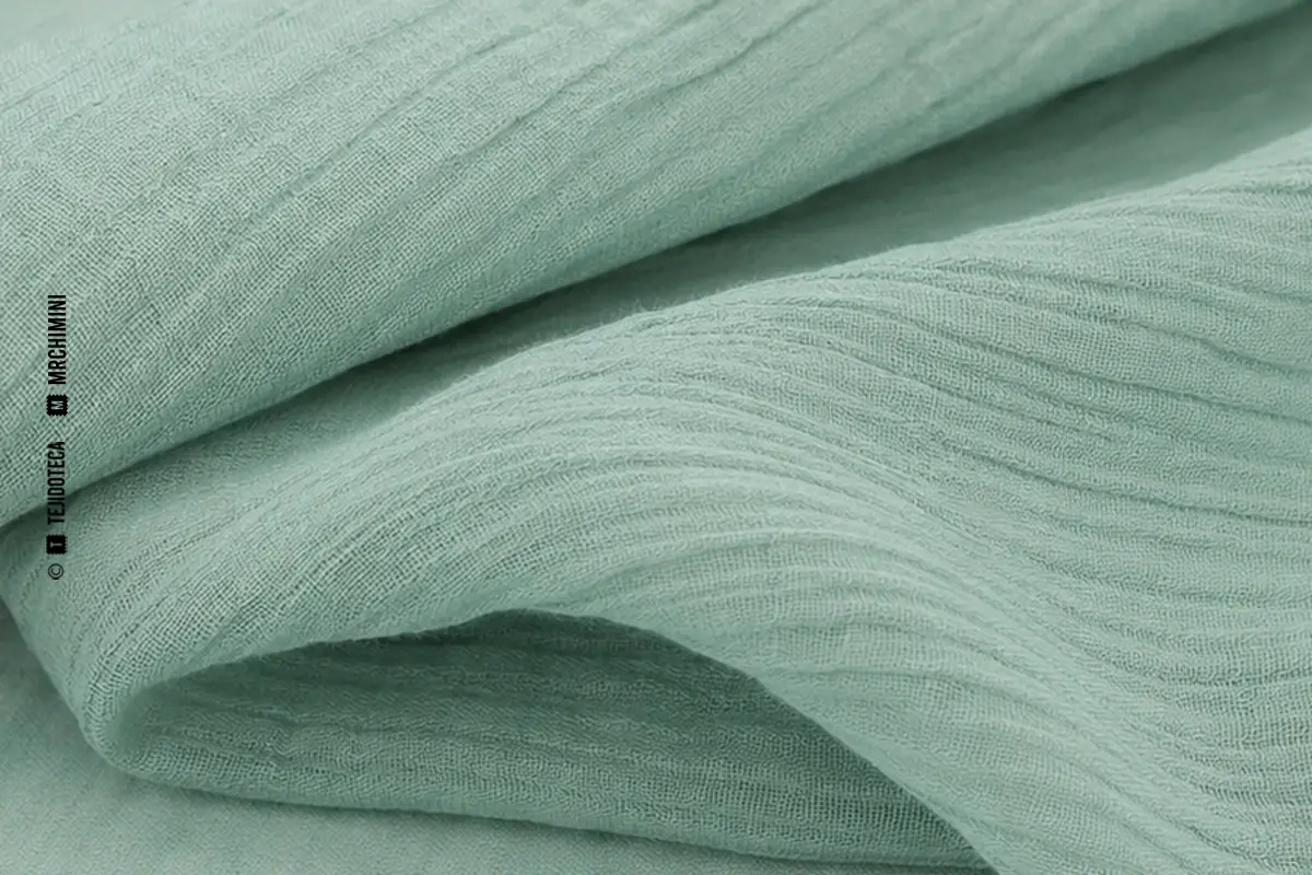 Macrofotografía de tejido bámbula en verde agua #86B7AD