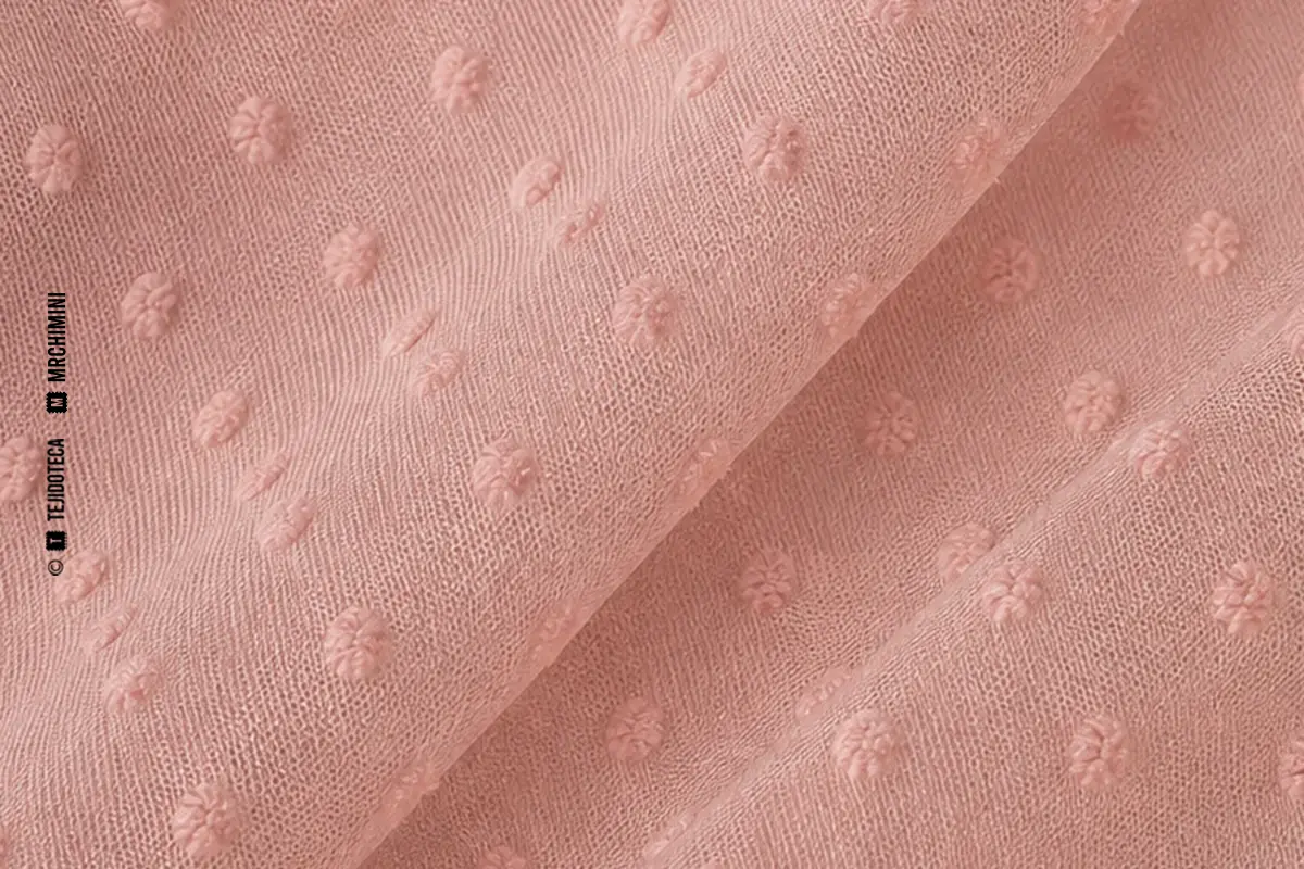 Macrofotografía de tejido plumeti en rosa empolvado #D9AEB8 con puntos del mismo tono