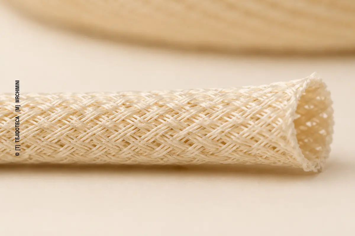 HILO TRENZADO – detalle macro Detalle macro de un hilo trenzado tubular con componentes entrecruzados diagonalmente.